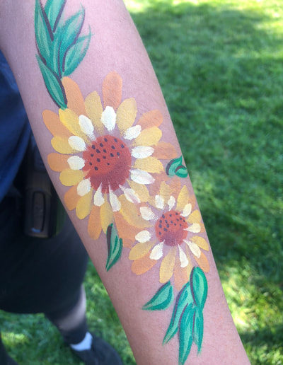 Girl with arm painting of sunflowers