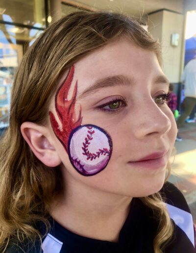 Teen with enflamed baseball painted on her cheek